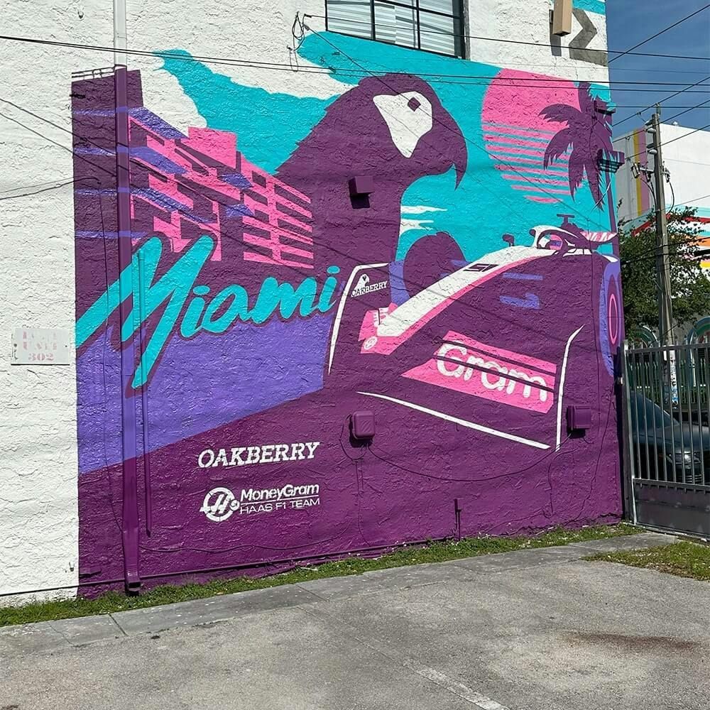 oakberry-difference.A mural of a race car and OAKBERRY's Logo a building